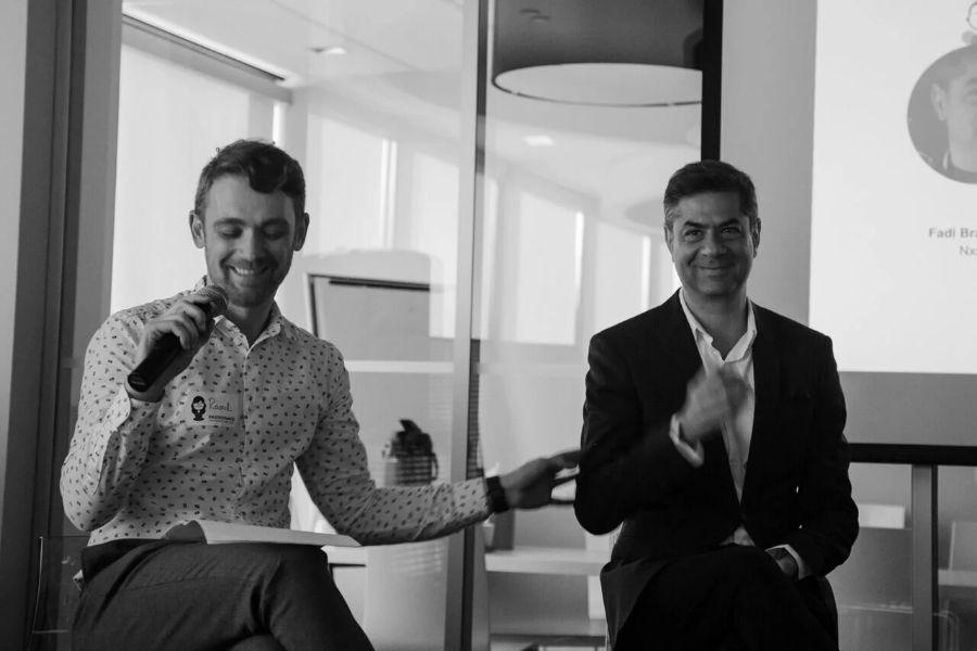 Two panelists sharing a laugh while hosting an InformalLab session