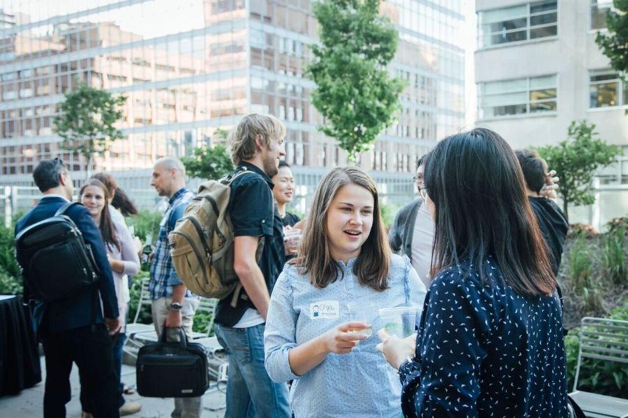 Attendees networking on a rooftop terrace after an InformalLab event